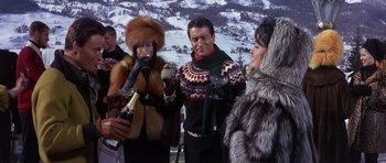 Movie still from “The Pink Panther” (1963), directed by Blake Edwards – A group of people standing next to each other in the snow; Medium shot, Low angle