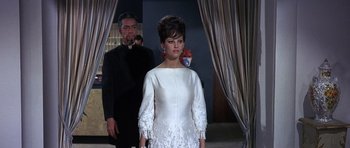 Movie still from “The Pink Panther” (1963), directed by Blake Edwards – A man and a woman standing in front of a curtain; Medium shot, Low angle