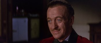 Movie still from “The Pink Panther” (1963), directed by Blake Edwards – A person wearing a suit and tie; Close Up shot, Over the shoulder angle