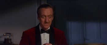 Movie still from “The Pink Panther” (1963), directed by Blake Edwards – A person wearing a suit and bow tie; Close Up shot, High angle