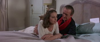 Movie still from “The Pink Panther” (1963), directed by Blake Edwards – A man and a woman sitting on a bed together; Medium shot, High angle