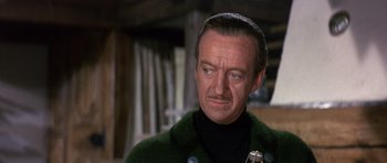 Movie still from “The Pink Panther” (1963), directed by Blake Edwards – A person wearing a suit and tie; Close Up shot, Low angle