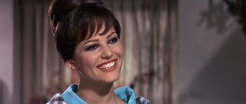 Movie still from “The Pink Panther” (1963), directed by Blake Edwards – A person with a smile on their face; Close Up shot, Over the shoulder angle