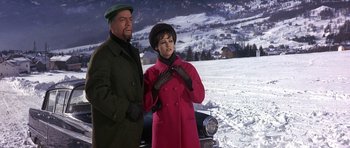 Movie still from “The Pink Panther” (1963), directed by Blake Edwards – A man and a woman standing next to a car; Medium shot, Low angle