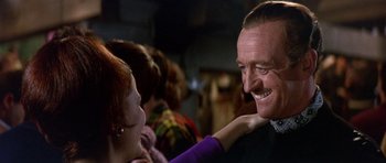 Movie still from “The Pink Panther” (1963), directed by Blake Edwards – A man and a woman smiling at each other; Close Up shot, Over the shoulder angle