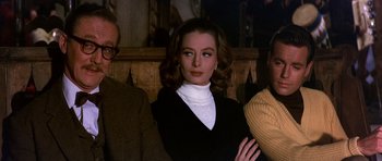 Movie still from “The Pink Panther” (1963), directed by Blake Edwards – A woman in a black sweater and a white shirt; Medium shot, Low angle