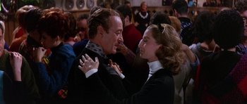 Movie still from “The Pink Panther” (1963), directed by Blake Edwards – A man and a woman are dancing in a crowd; Medium shot, Over the shoulder angle