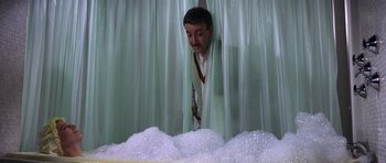 Movie still from “The Pink Panther” (1963), directed by Blake Edwards – A man standing in a room covered in bubbles; Medium shot, Low angle