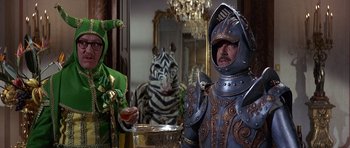 Movie still from “The Pink Panther” (1963), directed by Blake Edwards – Two people dressed in costumes in front of a mirror; Medium shot, Over the shoulder angle