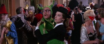 Movie still from “The Pink Panther” (1963), directed by Blake Edwards – A man and a woman dressed up in costumes; Medium shot, Over the shoulder angle