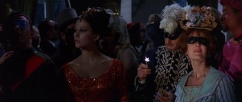 Movie still from “The Pink Panther” (1963), directed by Blake Edwards – A man and a woman dressed up in costumes; Medium shot, Over the shoulder angle