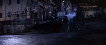 Movie still from “The Pink Panther” (1963), directed by Blake Edwards – A car driving down a street at night; Extreme Wide shot, High angle