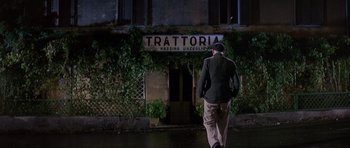 Movie still from “The Pink Panther” (1963), directed by Blake Edwards – A man walking down the street in front of a building; Wide shot, Low angle