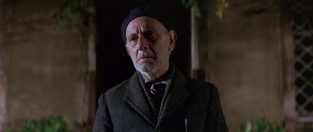 Movie still from “The Pink Panther” (1963), directed by Blake Edwards – An older man wearing a hat and a suit; Close Up shot, Low angle