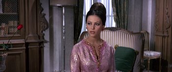 Movie still from “The Pink Panther” (1963), directed by Blake Edwards – A woman in a pink and gold dress; Medium shot, Over the shoulder angle