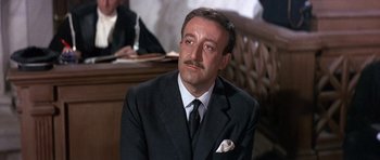 Movie still from “The Pink Panther” (1963), directed by Blake Edwards – A person wearing a suit and tie; Close Up shot, Low angle