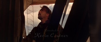 Movie still from “The Postman” (1997), directed by Kevin Costner – A person looking up at the sky; Close Up shot, Low angle