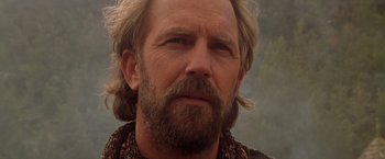 Movie still from “The Postman” (1997), directed by Kevin Costner – A person with long hair and a beard; Close Up shot, Low angle