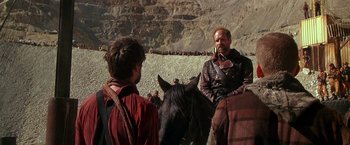 Movie still from “The Postman” (1997), directed by Kevin Costner – Two men on horseback in a mountainous area; Medium shot, Over the shoulder angle