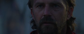 Movie still from “The Postman” (1997), directed by Kevin Costner – A person with a beard; Close Up shot, Over the shoulder angle