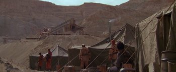 Movie still from “The Postman” (1997), directed by Kevin Costner – A group of men standing next to each other on top of a hill; Extreme Wide shot, Low angle