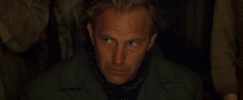 Movie still from “The Postman” (1997), directed by Kevin Costner – A person wearing a jacket; Close Up shot, Low angle