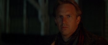 Movie still from “The Postman” (1997), directed by Kevin Costner – A person wearing a black shirt; Close Up shot, Over the shoulder angle