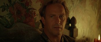 Movie still from “The Postman” (1997), directed by Kevin Costner – A person wearing a shirt; Close Up shot, Over the shoulder angle