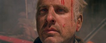 Movie still from “The Postman” (1997), directed by Kevin Costner – A person with blood on his face; Close Up shot, Low angle