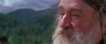Movie still from “The Postman” (1997), directed by Kevin Costner – An old man with a beard and a white beard; Close Up shot, Low angle