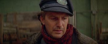 Movie still from “The Postman” (1997), directed by Kevin Costner – A person wearing a hat and a scarf; Close Up shot, Low angle