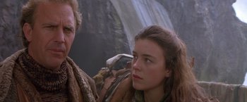 Movie still from “The Postman” (1997), directed by Kevin Costner – A young woman is looking at a waterfall while a young man looks on; Close Up shot, Over the shoulder angle