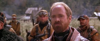 Movie still from “The Postman” (1997), directed by Kevin Costner – A man with a goatee and a beard; Close Up shot, Over the shoulder angle