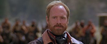 Movie still from “The Postman” (1997), directed by Kevin Costner – A person with a beard; Close Up shot, Over the shoulder angle