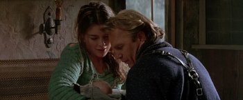 Movie still from “The Postman” (1997), directed by Kevin Costner – A man and a woman sitting next to each other; Close Up shot, Over the shoulder angle