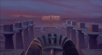 Movie still from “The Prince of Egypt” (1998), directed by Brenda Chapman – A painting of an egyptian statue in front of a castle; Extreme Wide shot, High angle