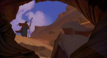 Movie still from “The Prince of Egypt” (1998), directed by Brenda Chapman – A painting of a man holding a staff in a cave; Wide shot, Low angle