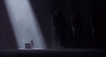 Movie still from “The Prince of Egypt” (1998), directed by Brenda Chapman – A man standing in front of a desk in a dark room; Extreme Wide shot, Low angle