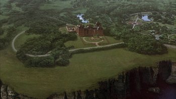 Movie still from “The Princess Diaries 2: Royal Engagement” (2004), directed by Garry Marshall – An aerial view of a castle with a garden in the center; Extreme Wide shot, Overhead angle