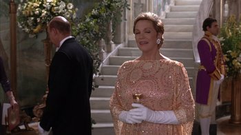Movie still from “The Princess Diaries 2: Royal Engagement” (2004), directed by Garry Marshall – An older woman in a pink dress holding a wine glass; Medium shot, Low angle