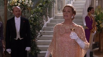 Movie still from “The Princess Diaries 2: Royal Engagement” (2004), directed by Garry Marshall – A woman in a pink dress holding a glass of wine; Medium shot, Low angle