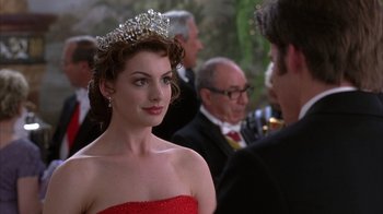 Movie still from “The Princess Diaries 2: Royal Engagement” (2004), directed by Garry Marshall – A woman in a red dress with a tiara on her head; Close Up shot, Over the shoulder angle