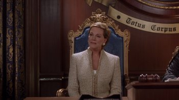 Movie still from “The Princess Diaries 2: Royal Engagement” (2004), directed by Garry Marshall – A woman sitting in a chair in a room; Medium shot, Low angle