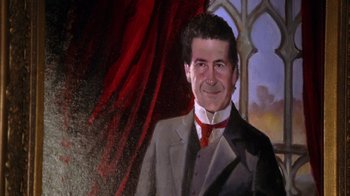 Movie still from “The Princess Diaries 2: Royal Engagement” (2004), directed by Garry Marshall – A painting of a man wearing a suit and a red neck tie; Close Up shot, Low angle