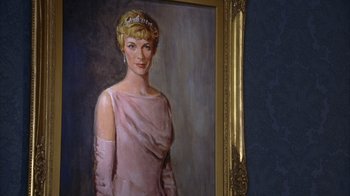 Movie still from “The Princess Diaries 2: Royal Engagement” (2004), directed by Garry Marshall – A painting of a woman wearing a pink dress and a tiara; Medium shot, Low angle