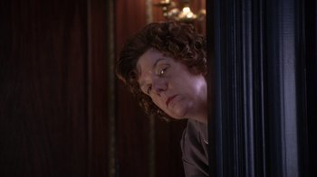 Movie still from “The Princess Diaries 2: Royal Engagement” (2004), directed by Garry Marshall – A woman with curly brown hair is looking out of a window; Close Up shot, Low angle