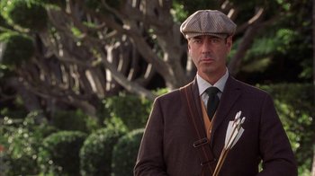 Movie still from “The Princess Diaries 2: Royal Engagement” (2004), directed by Garry Marshall – A man wearing a hat and holding a bow and arrow; Close Up shot, Low angle