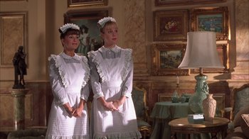 Movie still from “The Princess Diaries 2: Royal Engagement” (2004), directed by Garry Marshall – A couple of women standing next to each other in a room; Medium shot, Low angle