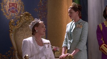 Movie still from “The Princess Diaries 2: Royal Engagement” (2004), directed by Garry Marshall – Two women dressed up in formal wear and one is wearing a tiara; Medium shot, Over the shoulder angle