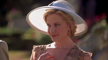 Movie still from “The Princess Diaries 2: Royal Engagement” (2004), directed by Garry Marshall – A woman wearing a white hat and a dress; Close Up shot, Over the shoulder angle
